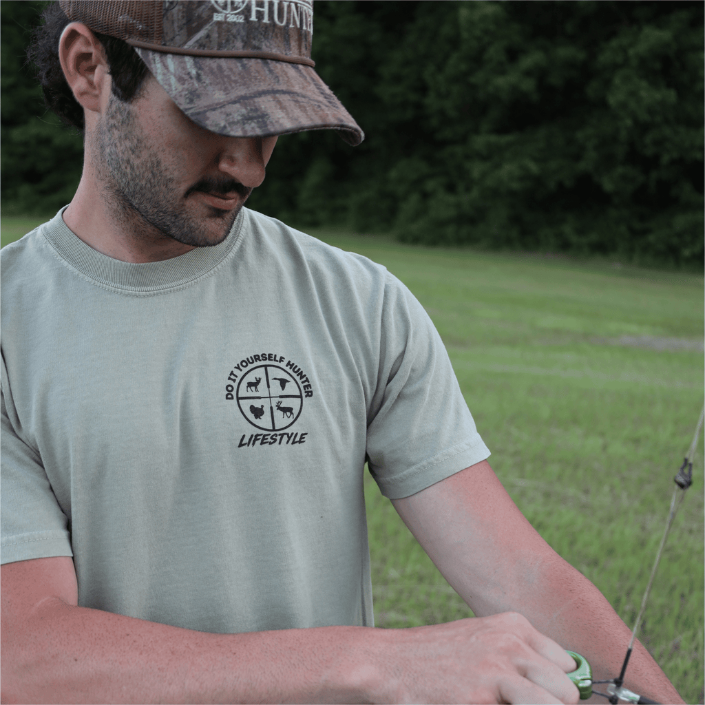 Black 250th House Buck T-shirt from the Do It Yourself Hunter lifestyle collection featuring a detailed buck graphic on the front.