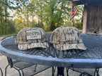 DO IT YOURSELF HUNTER camo cap with adjustable strap, designed for hunting and archery, featuring a camouflage pattern and curved brim.