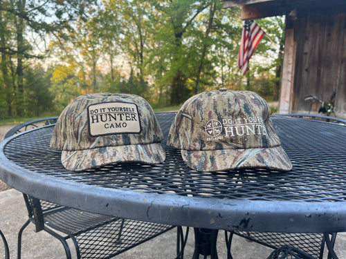 DO IT YOURSELF HUNTER camo cap with adjustable strap, designed for hunting and archery, featuring a camouflage pattern and curved brim.