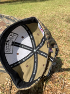 Inside view of a solid camo Do It Yourself Hunter cap showing the camouflage pattern and interior stitching details.